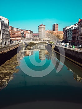 Puente de la Merced in Bilbao, reflections on the Ria de Bilbao on a sunny day