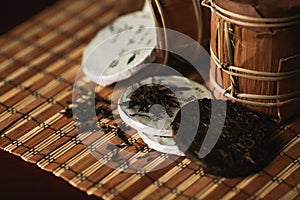 Puer tea with golden toad on a bamboo mat.