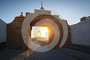 Puerta de la Caleta (La Caleta Gate) at sunset - access to Castle of San Sebastian - Cadiz, Andalusia, Spain photo