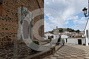 Puerta del PerdÃÂ³n of San Martin church with the mosque in the background in Almonaster la Real, Huelva, Spain photo