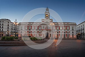 Puerta del Sol Square at sunrise with Royal House of the Post Office (Real Casa de Correos) - Madrid, Spain