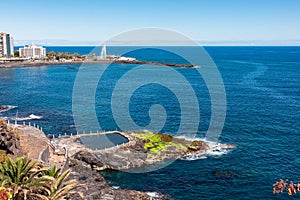 Puerto de la Cruz - Scenic view on coastline of tourist town Puerto de la Cruz, Tenerife, Canary Islands. Ocean bath in foreground