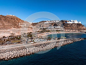 Puerto de Mogan fishing town aerial view at sunset.