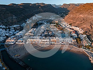 Puerto de Mogan fishing town aerial view at sunset.