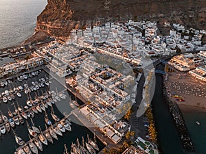 Puerto de Mogan fishing town aerial view at sunset.