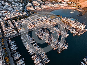 Puerto de Mogan fishing town aerial view at sunset.