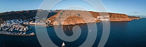 Puerto de Mogan fishing town aerial view at sunset.