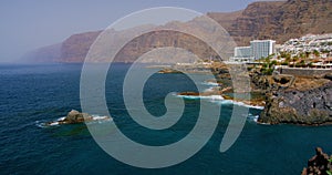 Puerto de Santiago village with Cliffs of the Giants in the background Tenerife, Canary islands, Spain. High quality