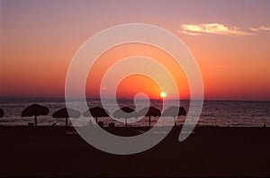 Puerto Escondido, Mexico: Sun setting over the ocean with moon already in the sky