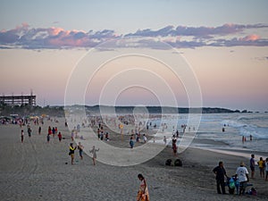 Puerto Escondido, Oaxaca, Mexico, South America: [Sunset at the local beach, lighthouse, crowdwed beach, tourist destination]