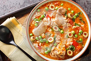 Puerto Rican dish asopao de pollo, a cross between soup and paella, is an easy, hearty one-dish meal featuring juicy chicken photo