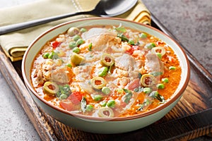 Puerto Rican dish asopao de pollo, a cross between soup and paella, is an easy, hearty one-dish meal featuring juicy chicken photo