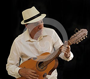 Puerto Rico Cuatro Player with a Panama hat.