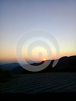 Puesta de sol tras las montaÃÂ±as en Michoacan photo