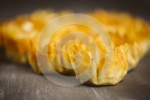 Puff pastries on a wooden background.