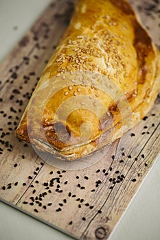 Puff pastries on a wooden background.