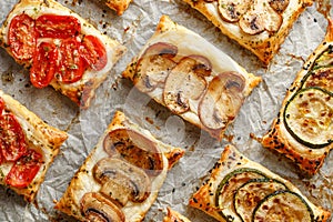 Puff pastry appetizers with vegetables; mushrooms, tomatoes and zucchini