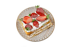 Puff pastry cake with whipped curd cream and fresh strawberries isolated on white background