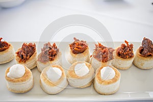 Puff pastry canapes with Iberian chorizo and Torta del Casar cheese photo