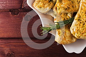 Puff pastry with cheese and herbes de Provence on wooden planks toned selective focus