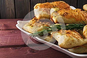 Puff pastry with cheese and herbes de Provence on wooden planks toned selective focus