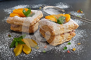 Puff pastry cookies with chocolade cream and tinned apricots