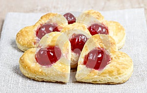 Puff pastry cookies in heart shape filled with cherries