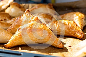 Puff pastry with cottage cheese. Puff pastry triangles with feta cheese on a protvin on a table