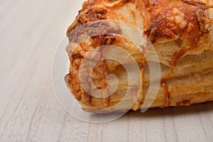 Puff pastry with cottage cheese on wooden background. Copy space