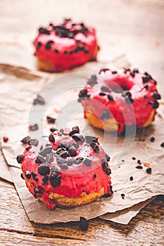 Puff pastry donuts with pink icing and cookie chips