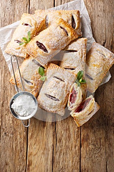 Puff pastry filled with cherry jam close-up. Vertical top view