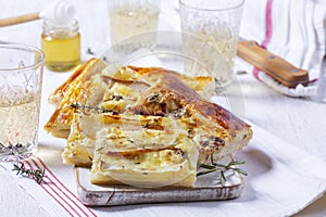 Puff pastry pie with cheese, pears, nuts and honey, served with champagne.