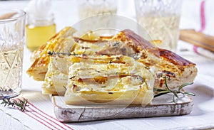 Puff pastry pie with cheese, pears, nuts and honey, served with champagne.