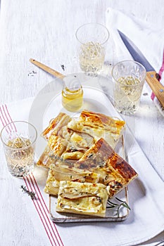 Puff pastry pie with cheese, pears, nuts and honey, served with champagne.