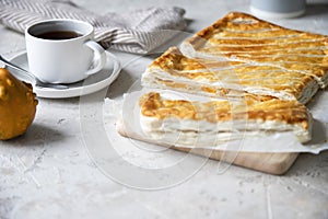 Puff pastry pie with pumpkin, onion and cheese on grey background
