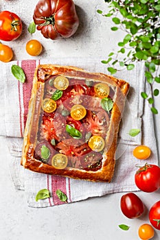 Puff pastry pie with tomatoes and basil