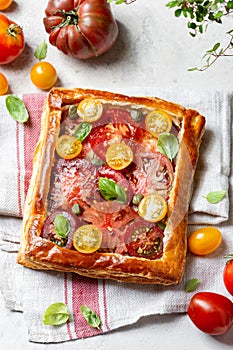 Puff pastry pie with tomatoes and basil