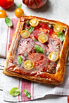 Puff pastry pie with tomatoes and basil
