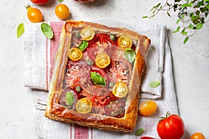 Puff pastry pie with tomatoes and basil