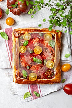 Puff pastry pie with tomatoes and basil