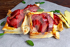 Puff pastry pies with plums, apples, mint and honey