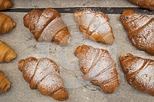 Puff pastry rolls. fresh sweet baking on papyrine. crispy pies lie in rows on a baking sheet on the counter. Top view, tasty delic photo