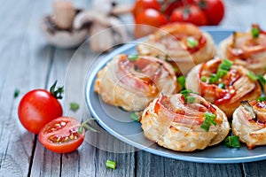 Puff pastry rolls with ham and chese. Baked snacks