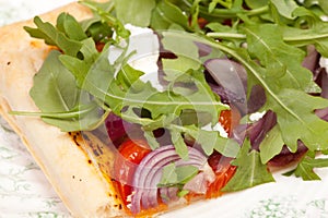 Puff pastry with tomatos onions rocket salad and goats cheese