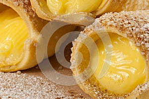 Puff pastry vanilla horns on a wooden board