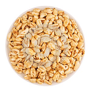 Puffed air rice wheat in bowl, top view, isolated on white background.