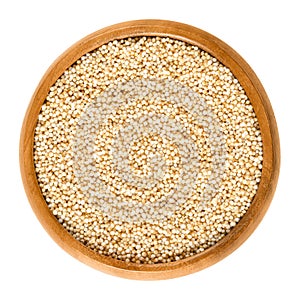 Puffed amaranth in wooden bowl over white