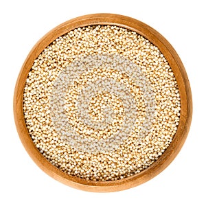 Puffed amaranth in wooden bowl over white photo