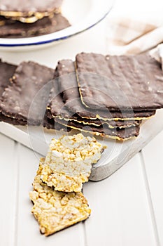 Puffed corn crackers chocolate covered on white table