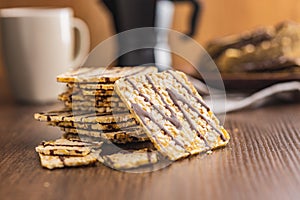 Puffed corn crackers chocolate covered on wooden table